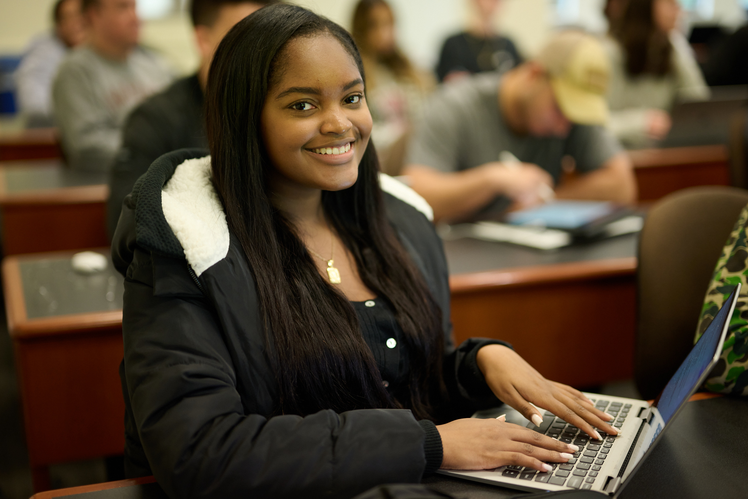 Student posing for photo in a classroom