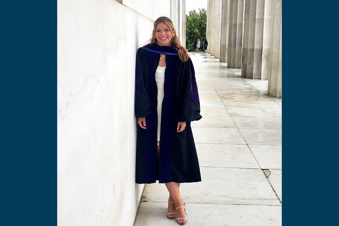 Christina Morgan posing with her graduation robe on