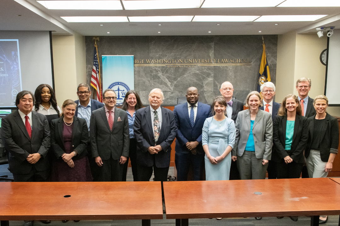 The GW Law group with their symposium panelists posing for a picture