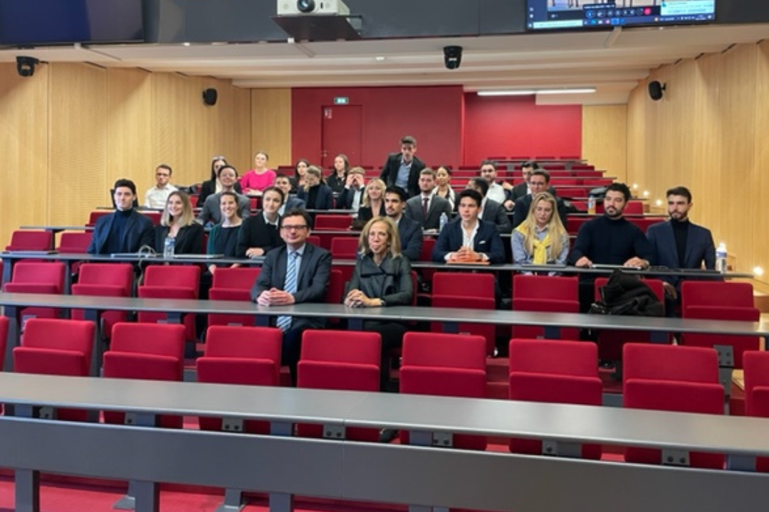 Professor Karen B. Brown sitting in front of students in an auditorium