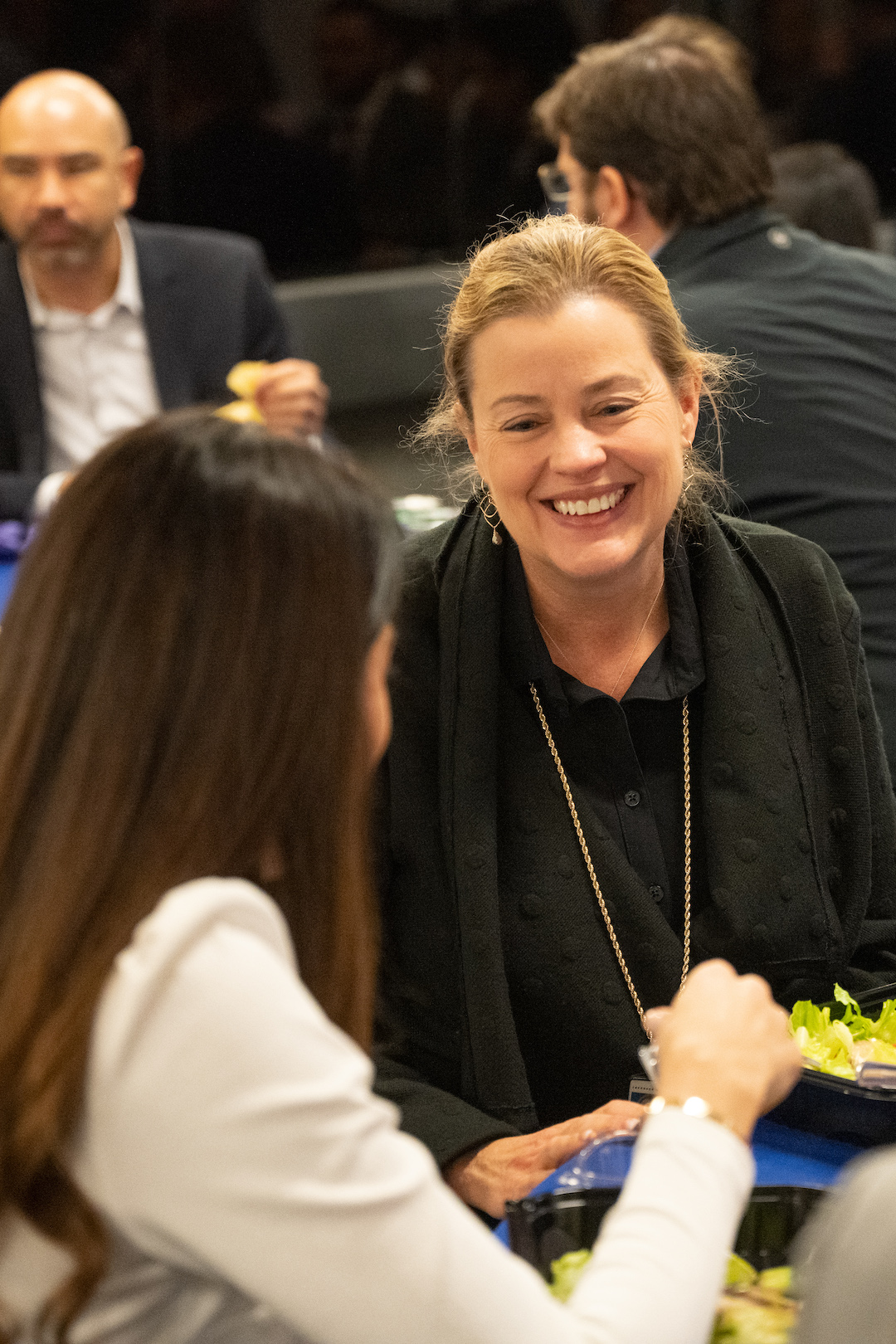 Adriana Luedke smiling as she speaks to a student