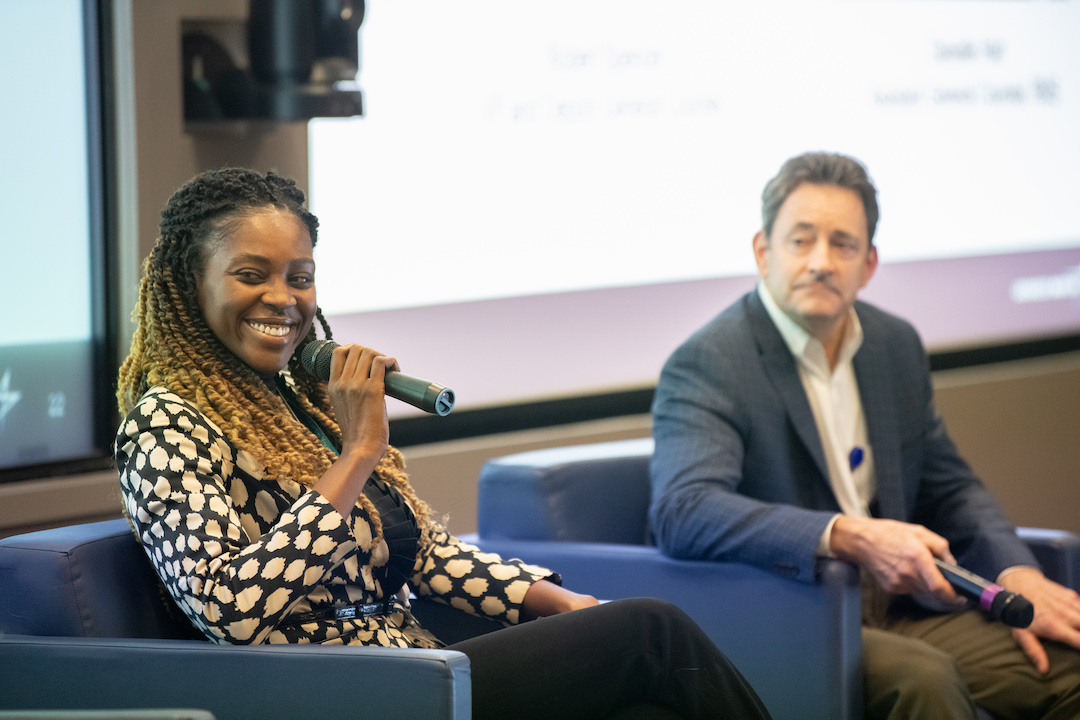 Danielle Hart holds microphone and speaks to students