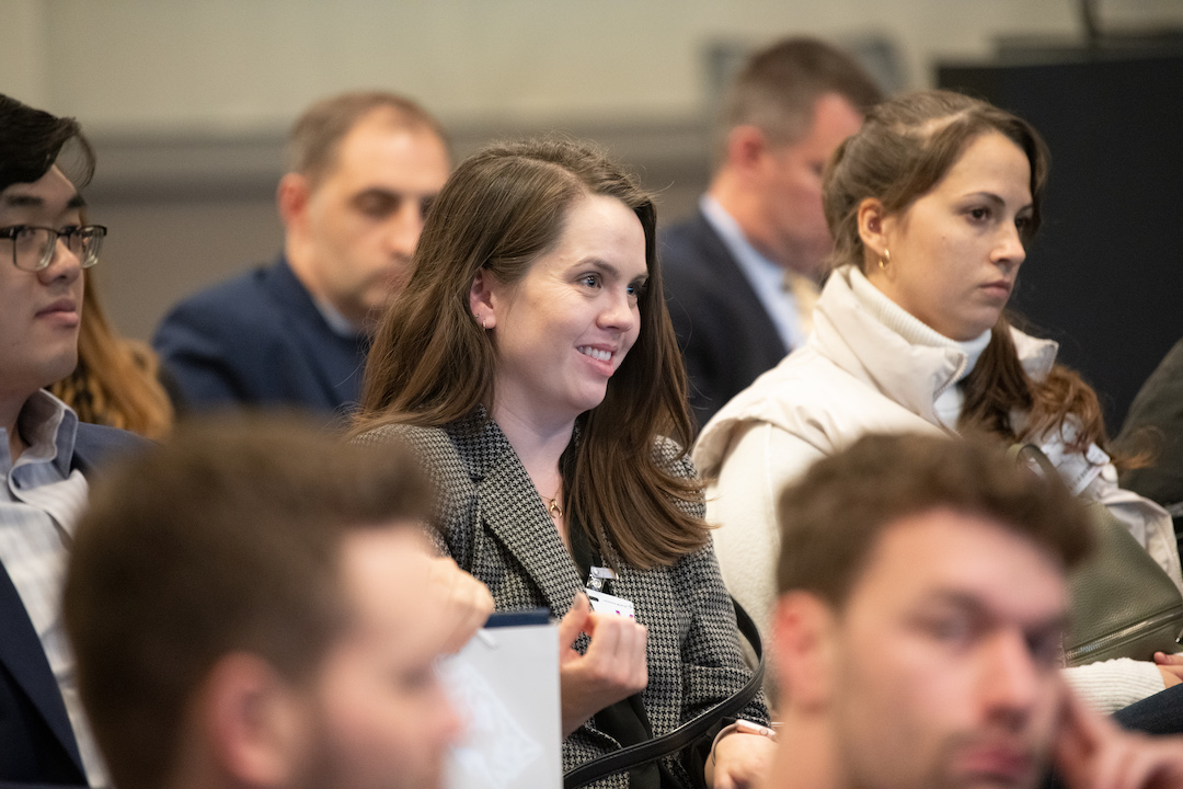 Students listening to a presentation with one girl smiling