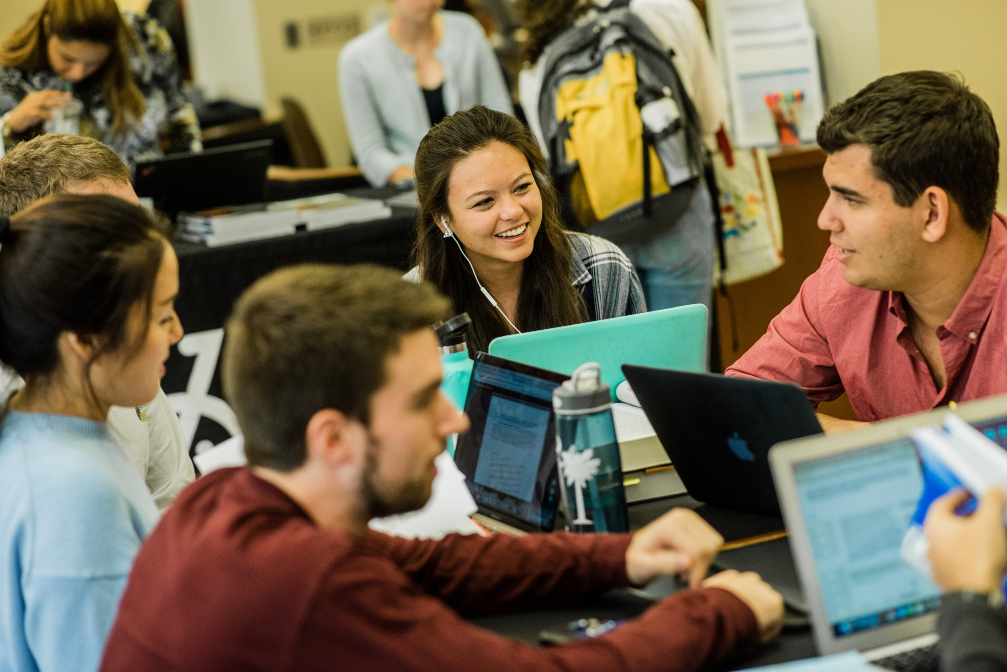 Students working and talking in library