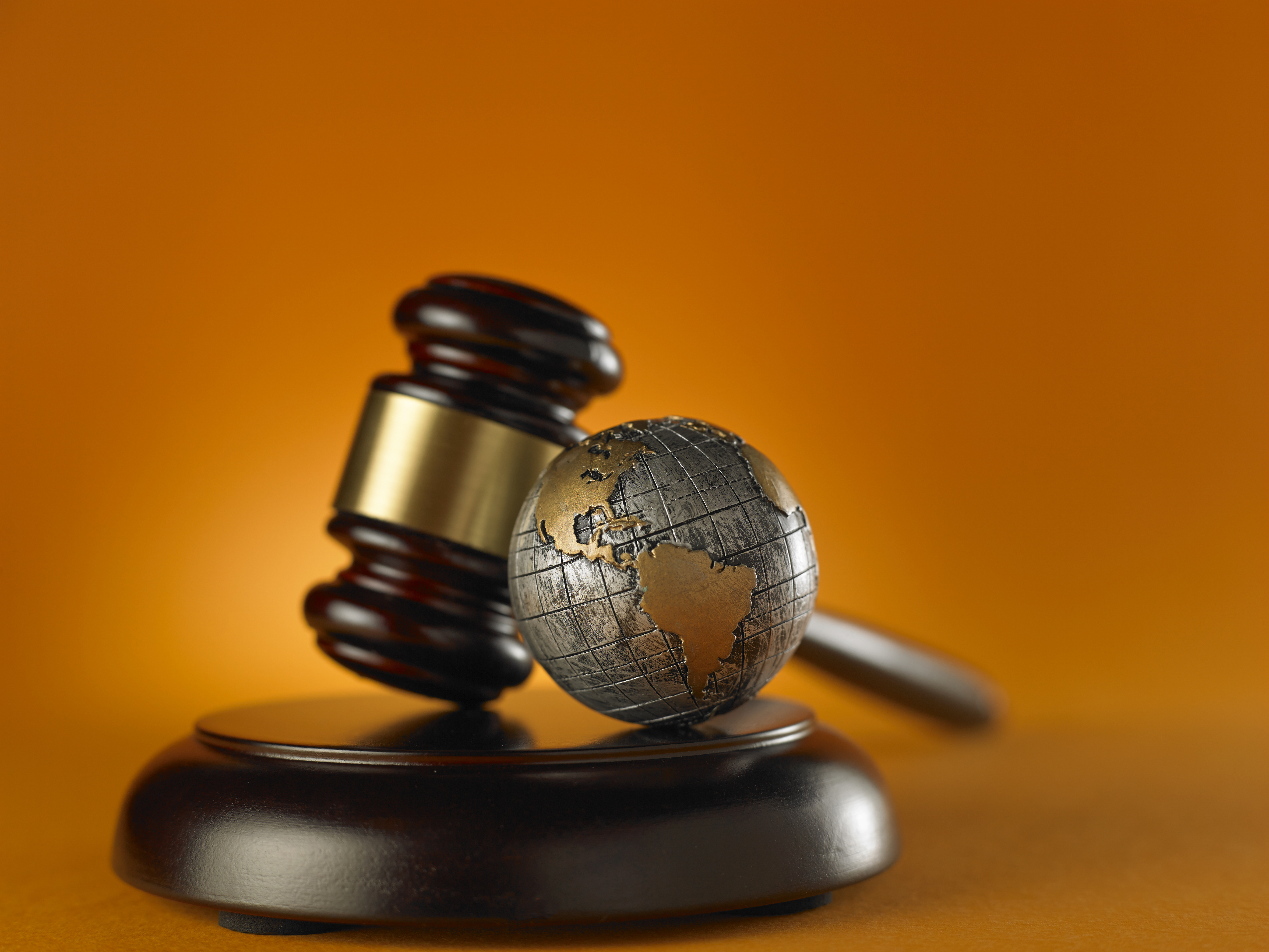 A gavel with a globe next to it