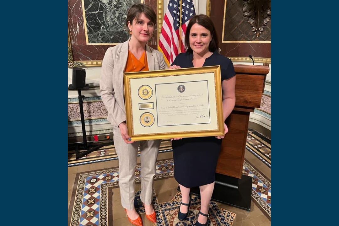 Cori Alonso-Yoder and Rachel Micah-Jones holding the Presidential Award for Extraordinary Efforts to Combat Trafficking in Persons