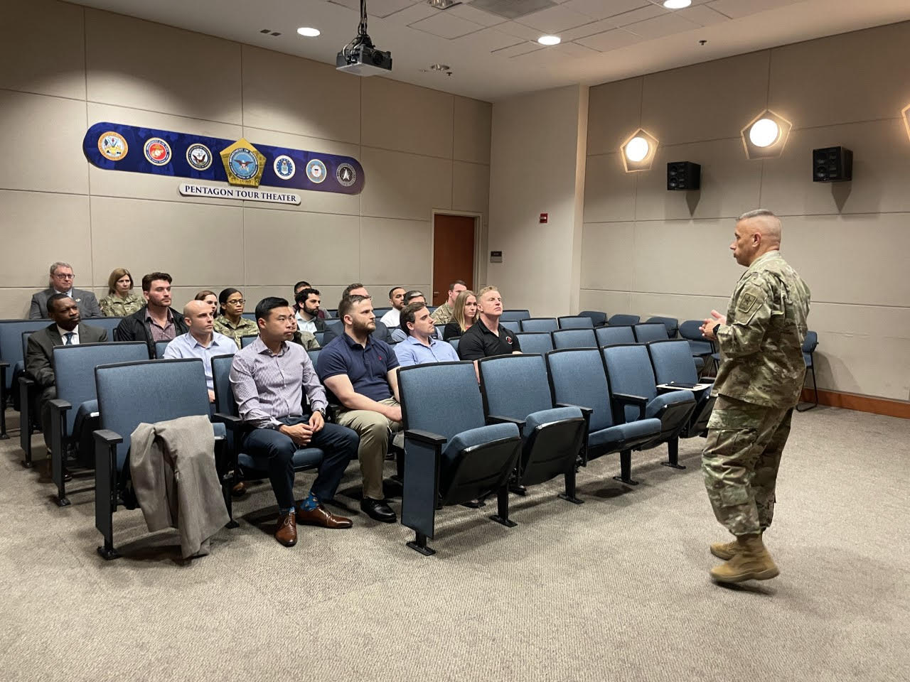 Students listening to a military man