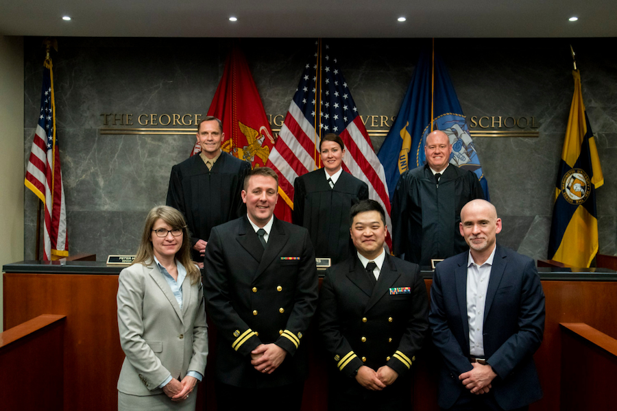 Appellate judges Captain Amanda Myers, Colonel Peter Houtz, and Captain Colin Kisor with the defendants and plaintiffs