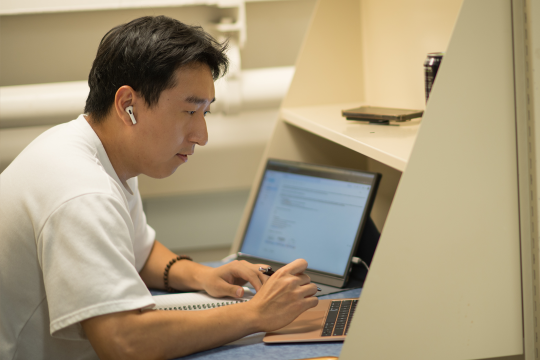 Student working on his computer in the law library.