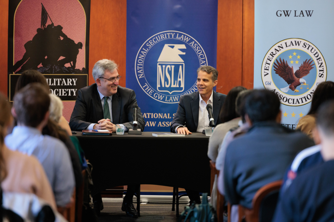 Professor Dan Richard and Eric O'Neill talking in front of a room of listeners