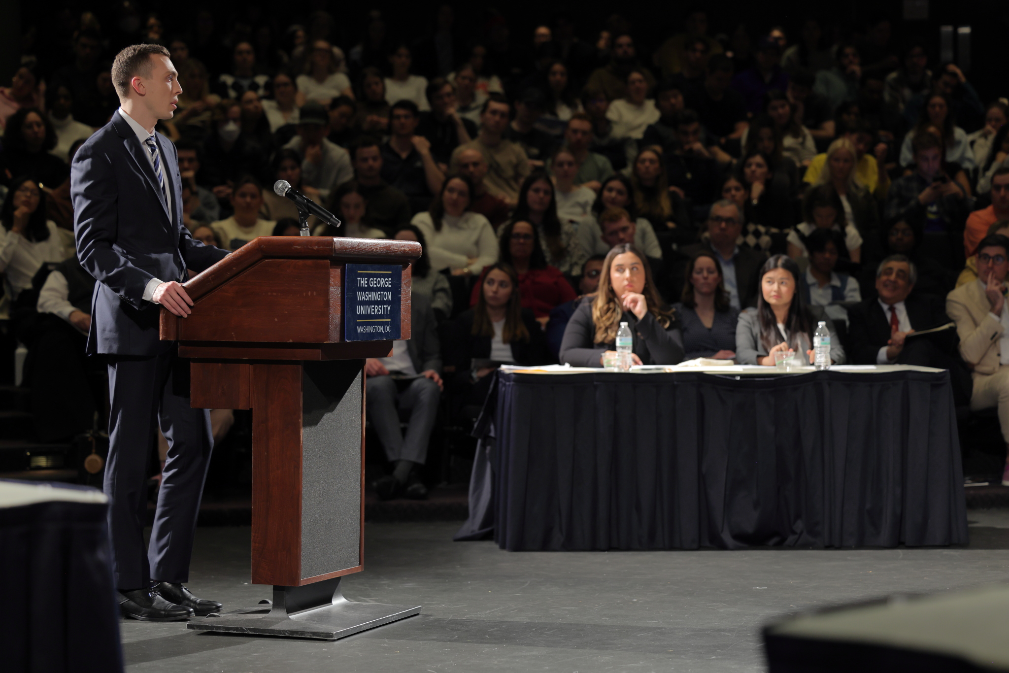 Simon Poser standing behind a lectern giving his oral argument