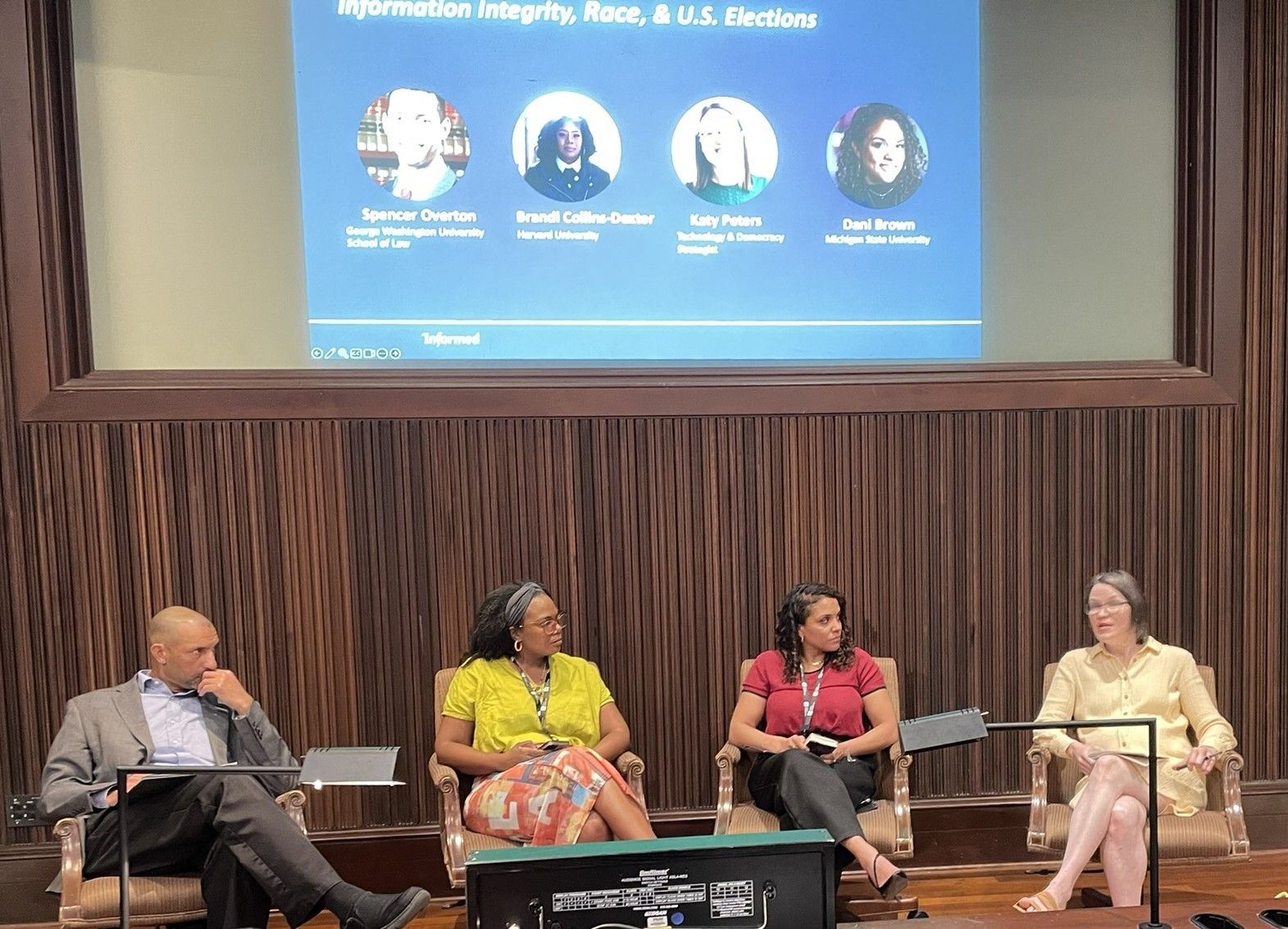 Spencer Overton and 3 colleagues sitting and talking