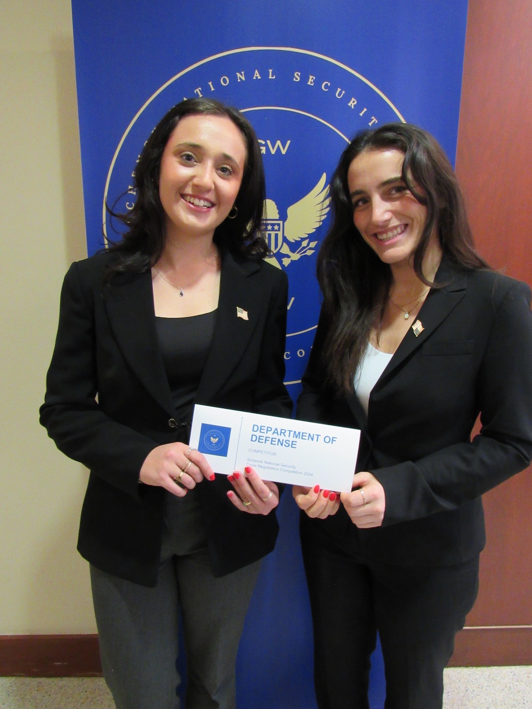 Talia Spillerman and Alex Greenberg, Class of 2026 Alex Greenberg and Talia Spillerman holding Department of Defense sign