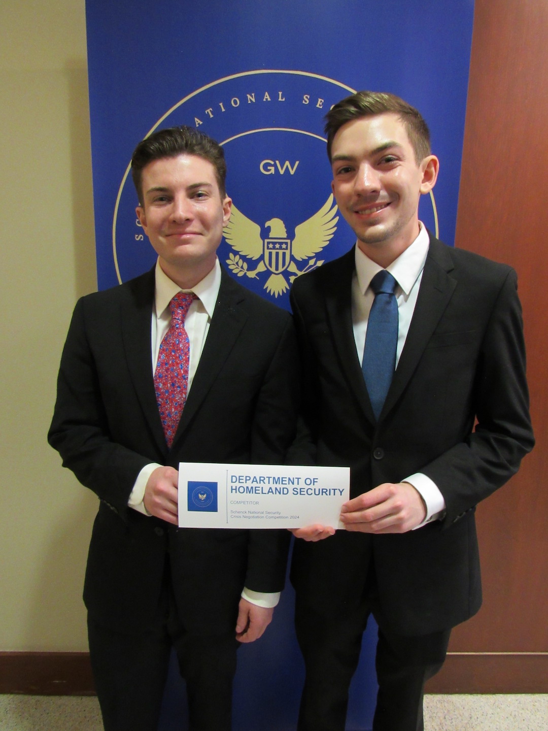 Sam Girioni and Austin Yanoti, Class of 2026 Austin Yanoti and Sam Girioni holding a Department of Homeland Security sign