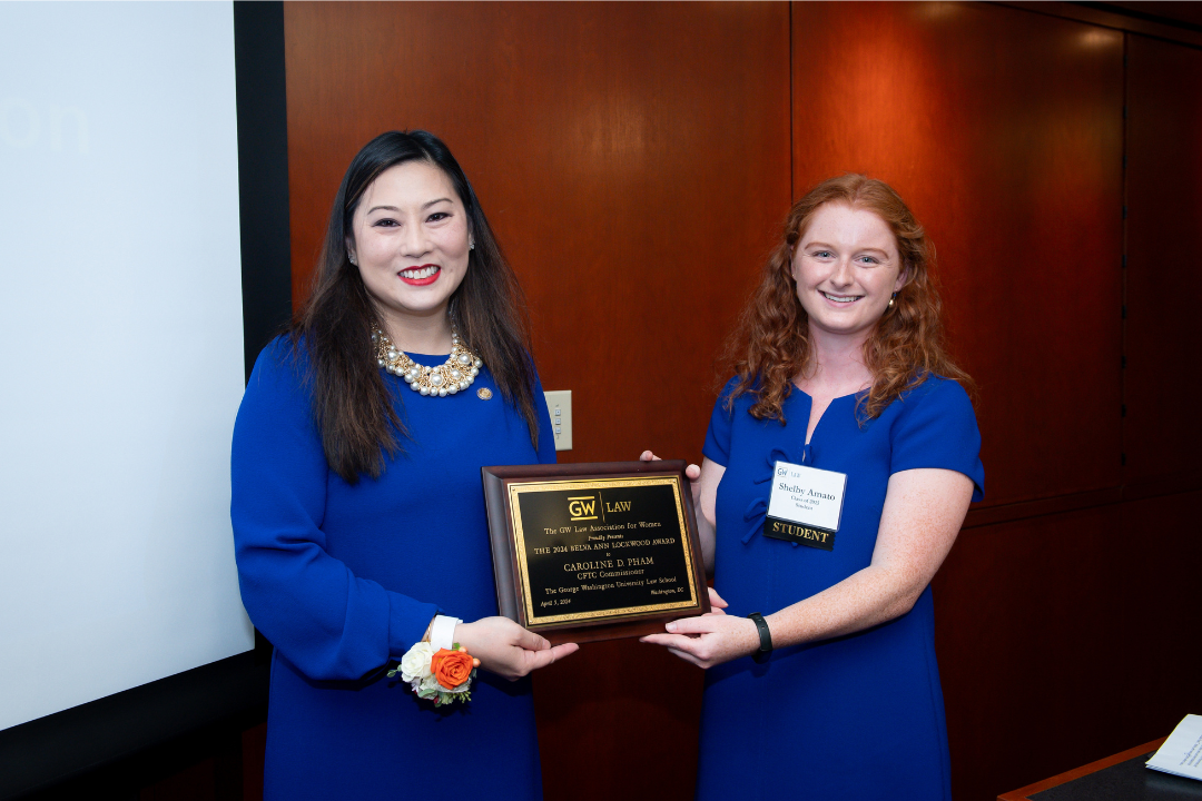 Caroline Pham and Shelby Amato holding the Belva Ann Lockwood plaque