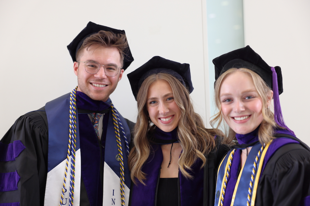 three law graduates in their regalia