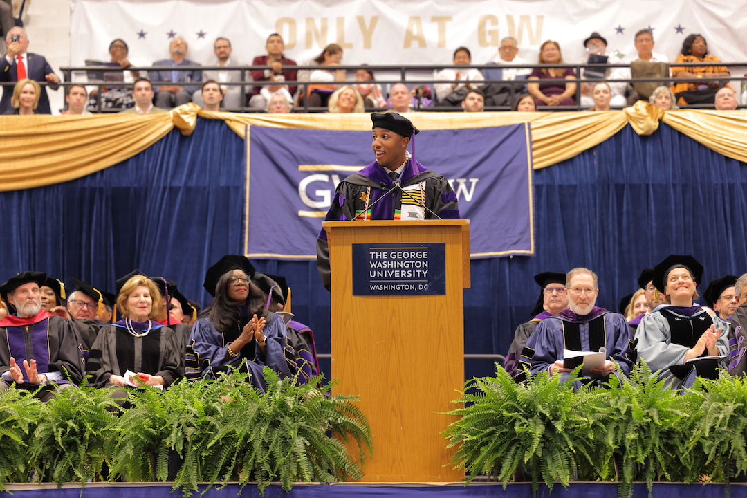 Shallum Atkinson speaking at a podium