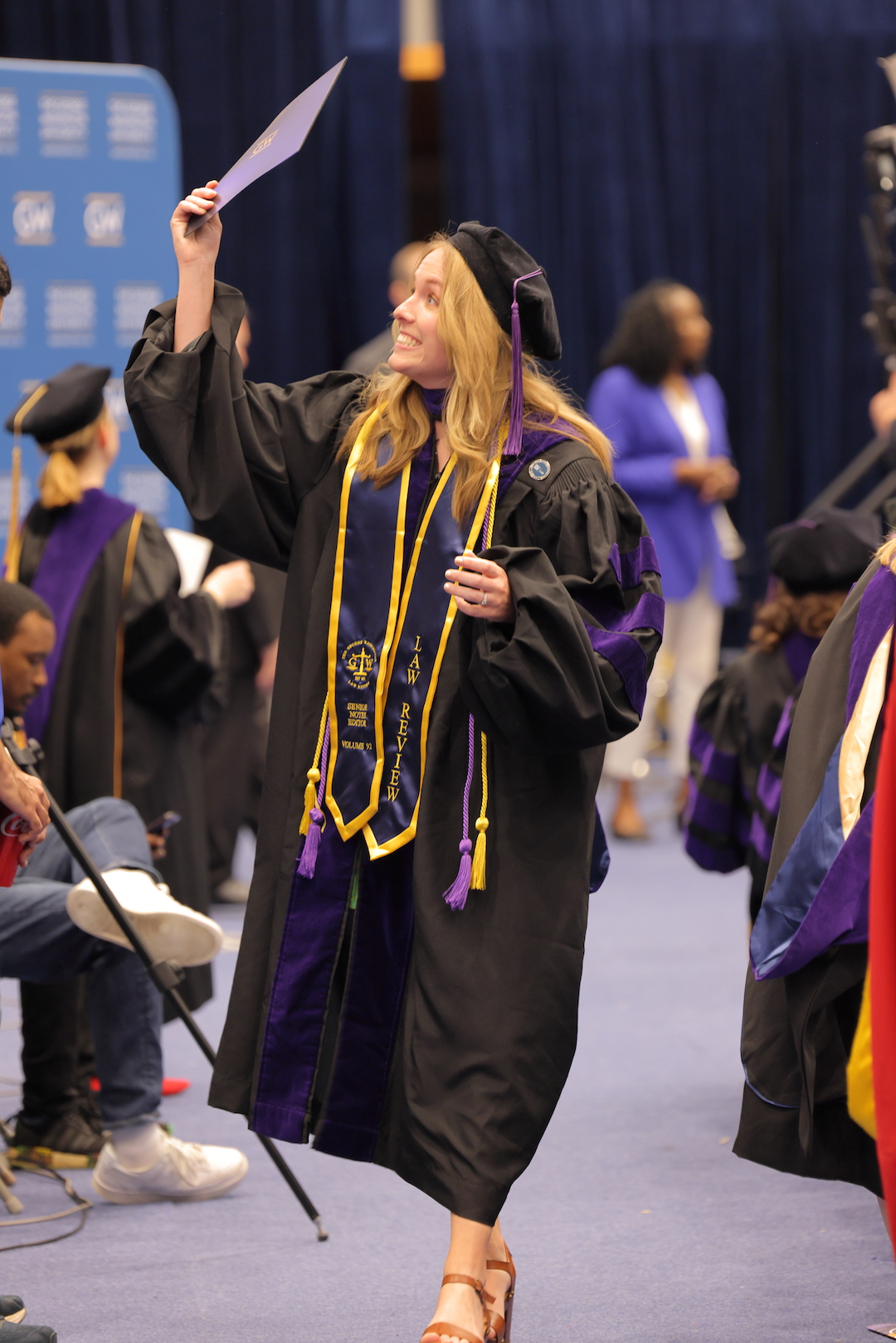 A law graduate showing off her diploma envelope