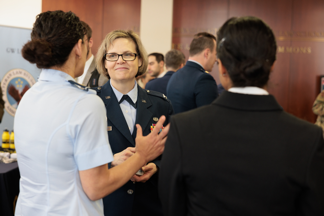An officer speaking to two students