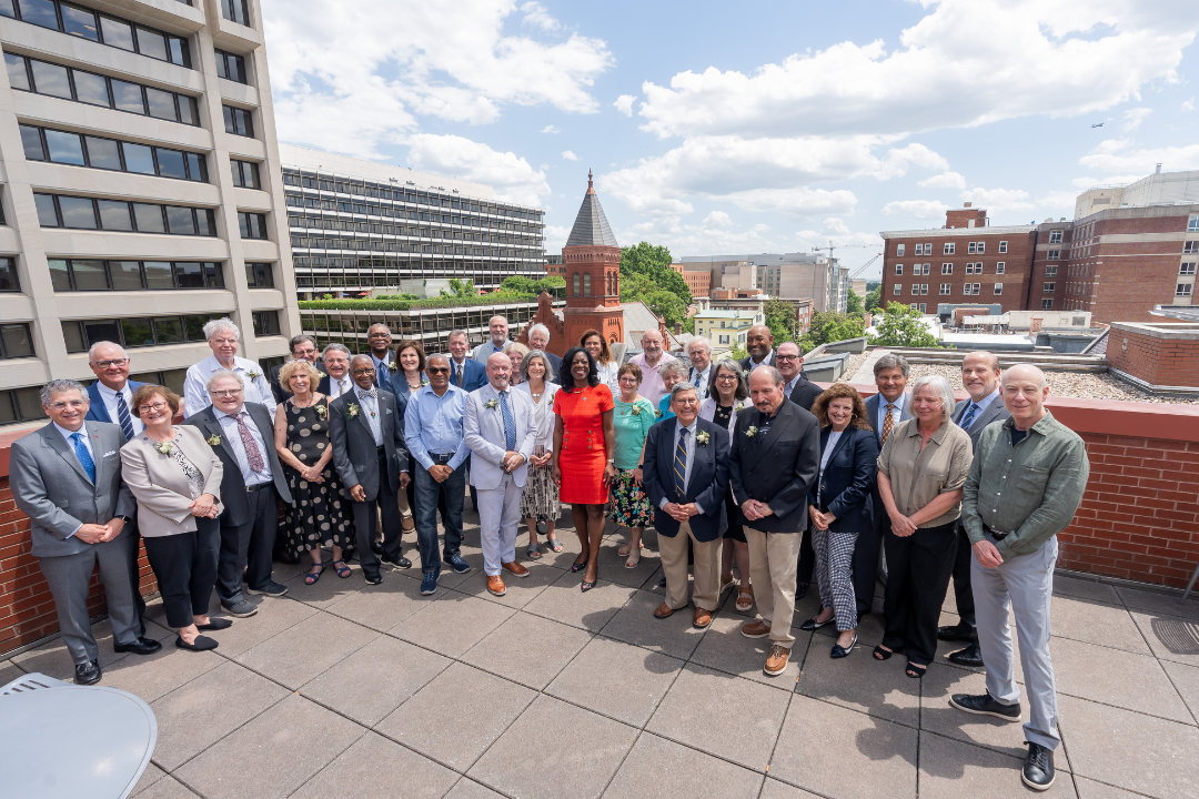 Multiple people standing for a picture on GW Law's rooftop