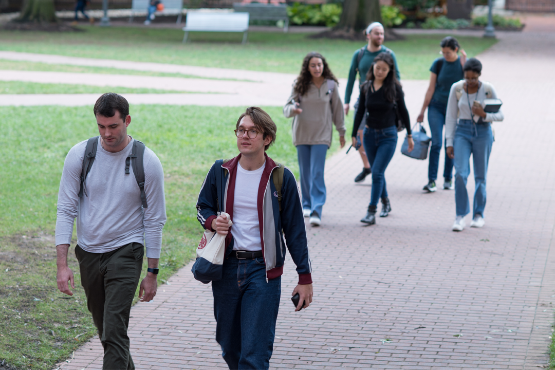 Group of students walking on the University yard.