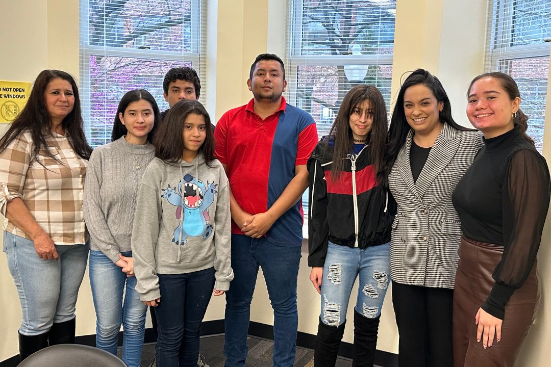 Professor Paulina Vera, a student, and immigration clinic clients