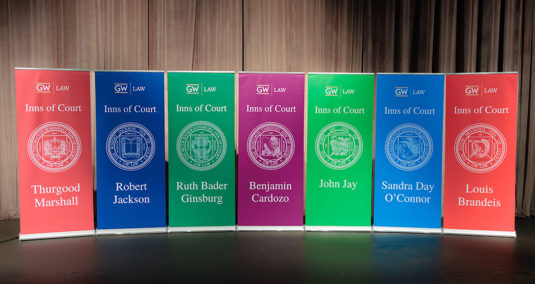Inns of Court banners lined up on a stage