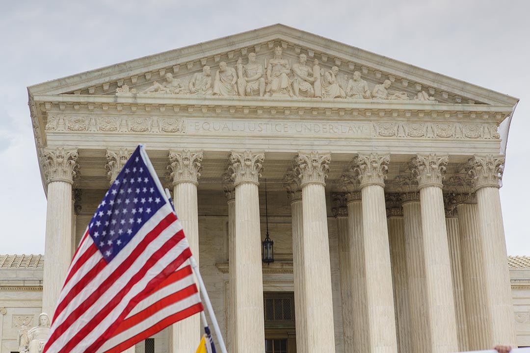 US Supreme Court building. The American Flag is visible in front of the building.