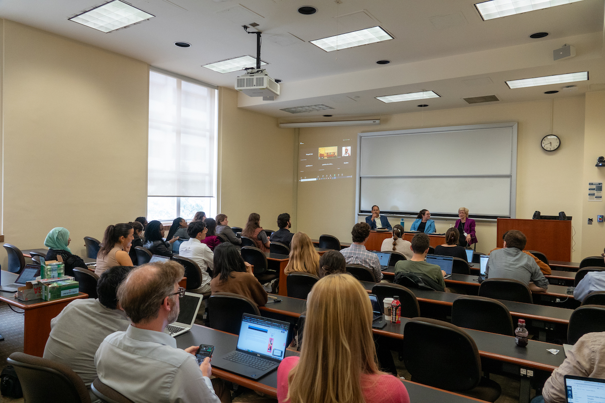 Attendees in front of the panel of speakers 
