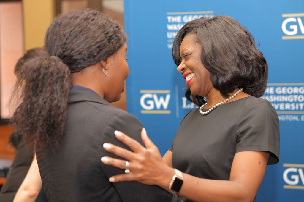 GW Law Dean Dayna Bowen Matthew hugs a student during the 2024 Midyear Graduation Luncheon