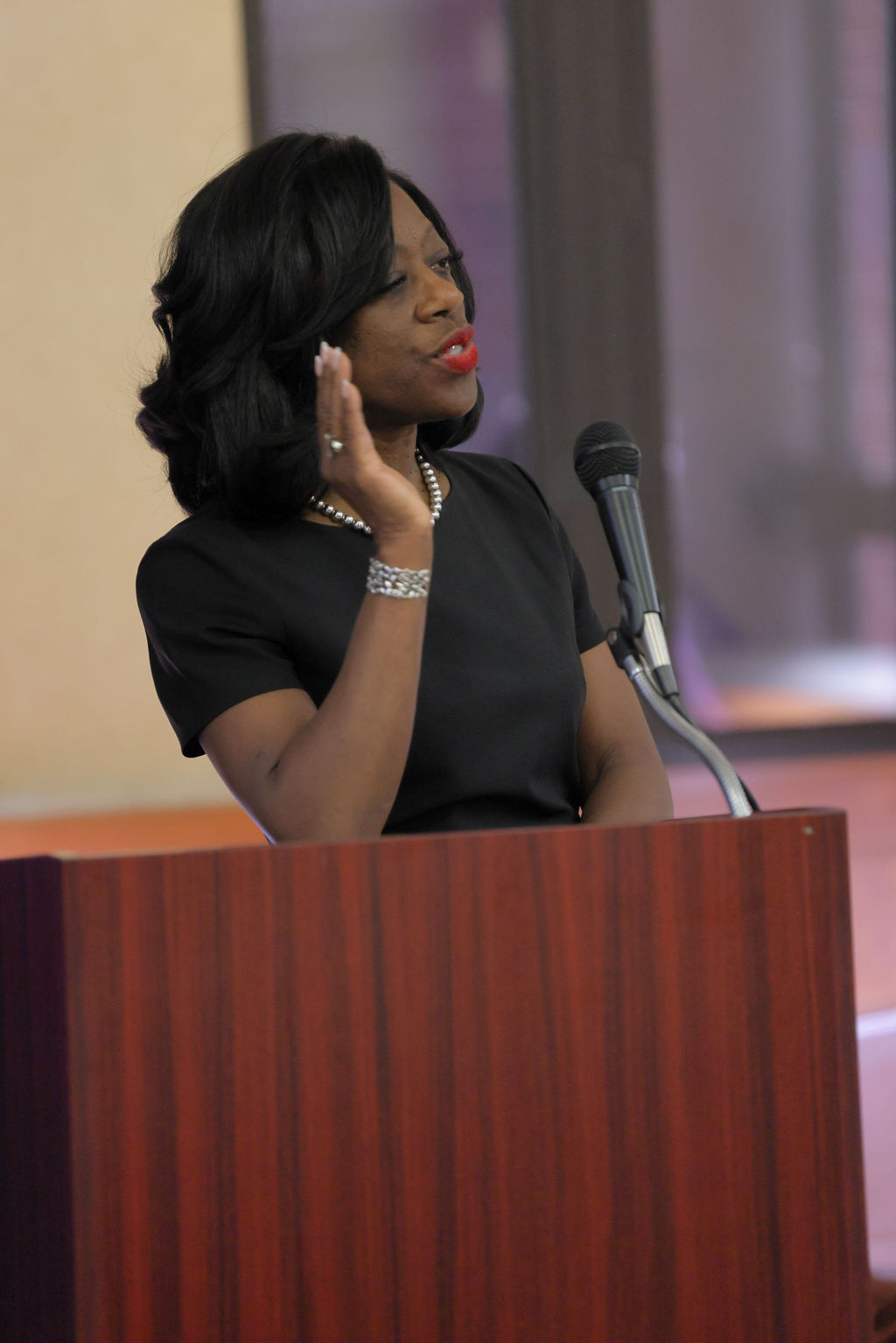 Dean Dayna Bowen Matthew speaks at a podium during the 2024 Midyear Graduation Luncheon.