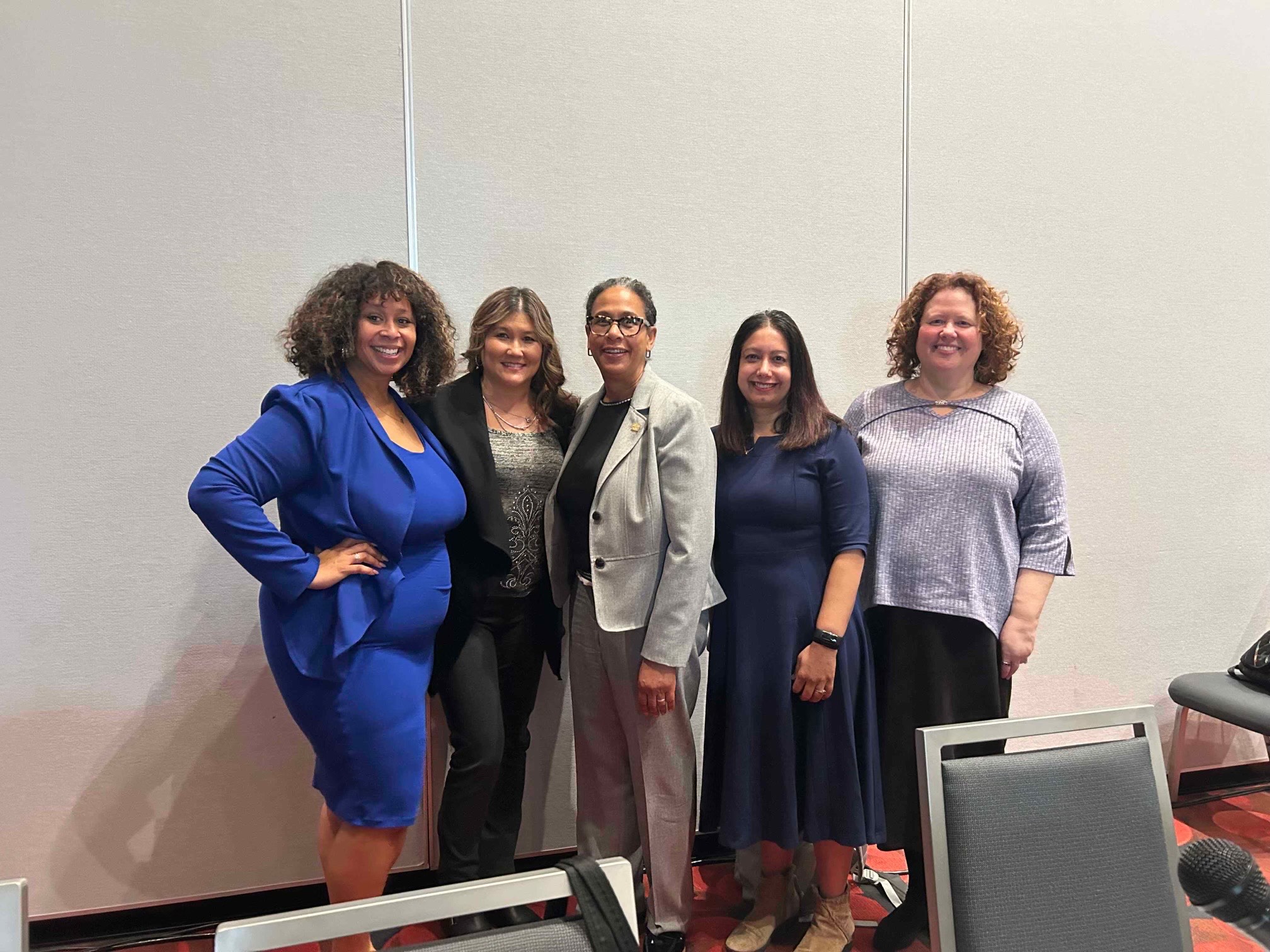 GW Law Associate Dean Carmia Caesar poses in a photo with a group of women during the 2025 AALS meeting in San Francisco.