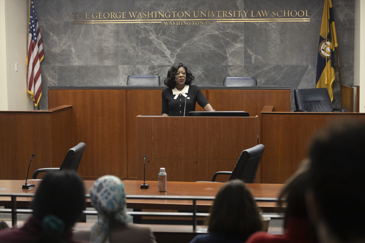 Students watch GW Law Dean Dayna Bowen Matthew speaking at a podium during the 2025 GW JOLT symposium.