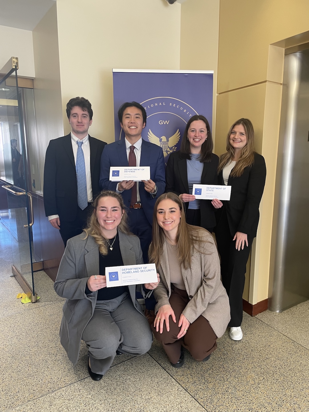 Schenck-2025-4 Students pose with placards during the 2025 Schenck National Security Competition