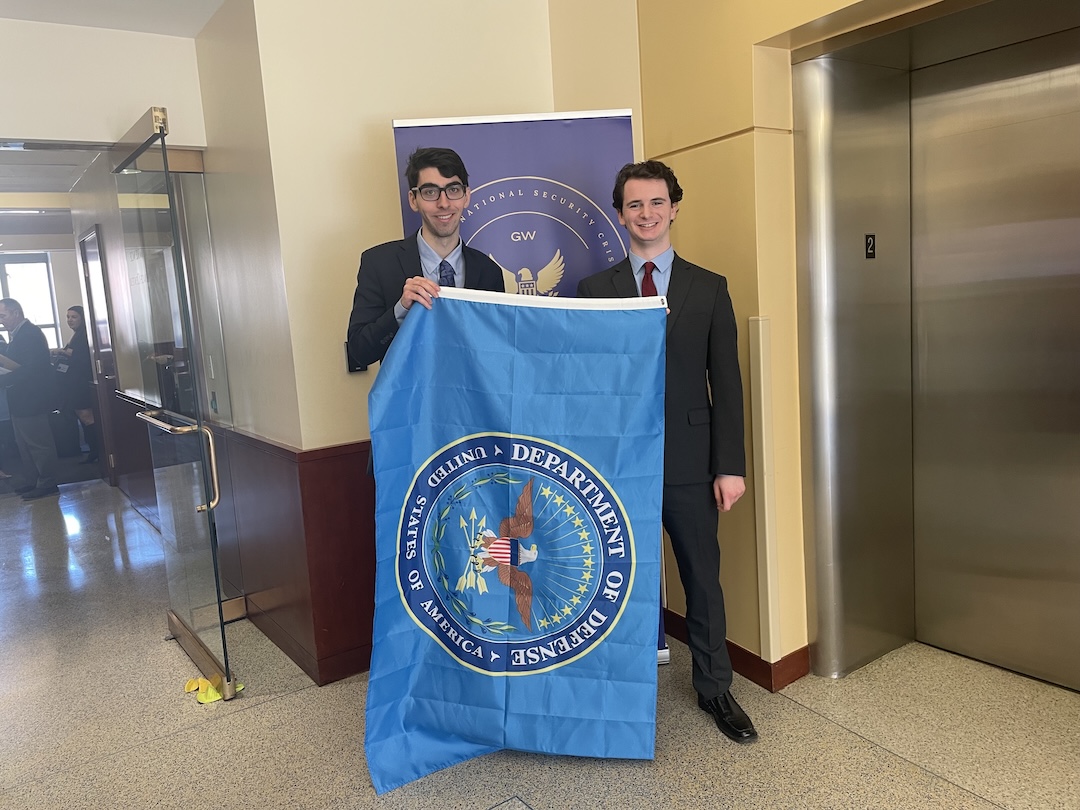 Schenck-2025-3 Two students pose with a Department of Defense flag during the 2025 Schenck National Security Competition