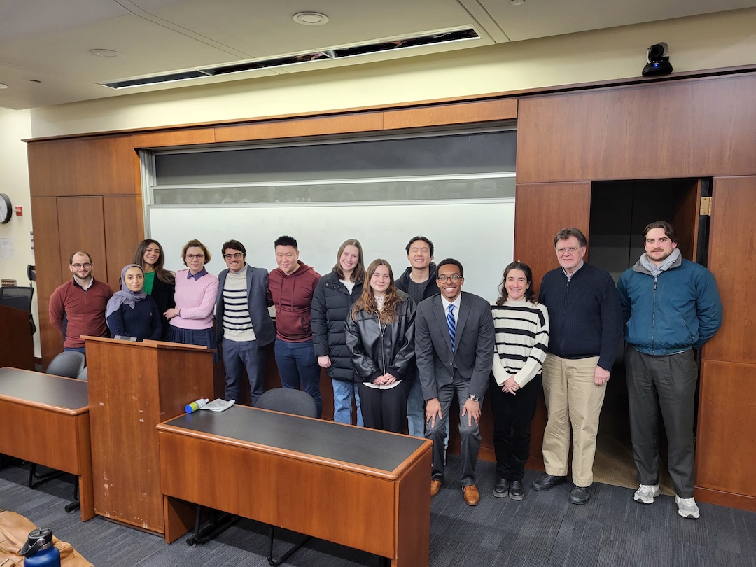 JD and LLM students pose for a photo in a moot court room.