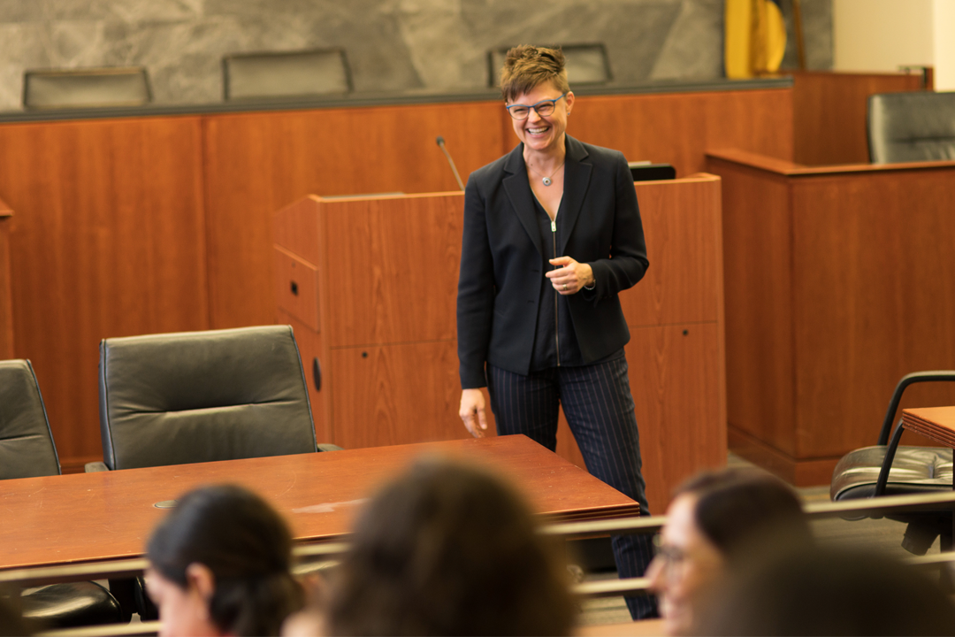 Emily Hammond speaking in front of a class in the Burns Moot Courtroom