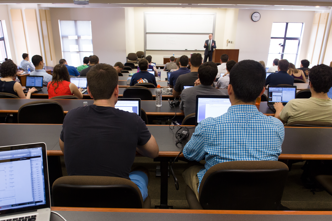 A professor teaching a class in the Burns Moot Courtroom classroom.
