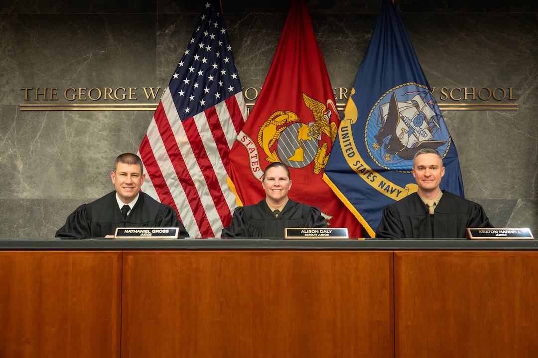 Navy-Marine Corps Court of Criminal Appeals Judges (Colonel) Alison Daly, (Captain) Nathaniel Gross, and (Lieutenant Colonel) Keaton Harrell sit in the judges bench in Burns Moot Court Room.
