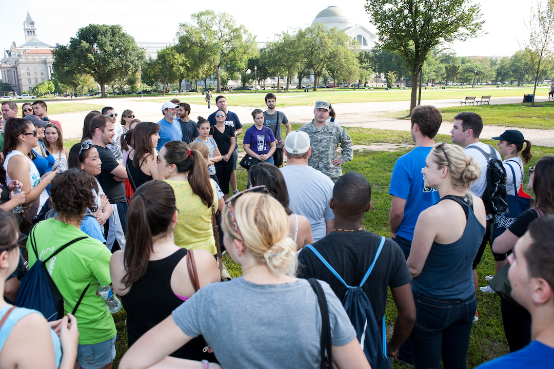 Public Interest students gathered in a circle around a United States Marine who was speaking to them on the National Mall.
