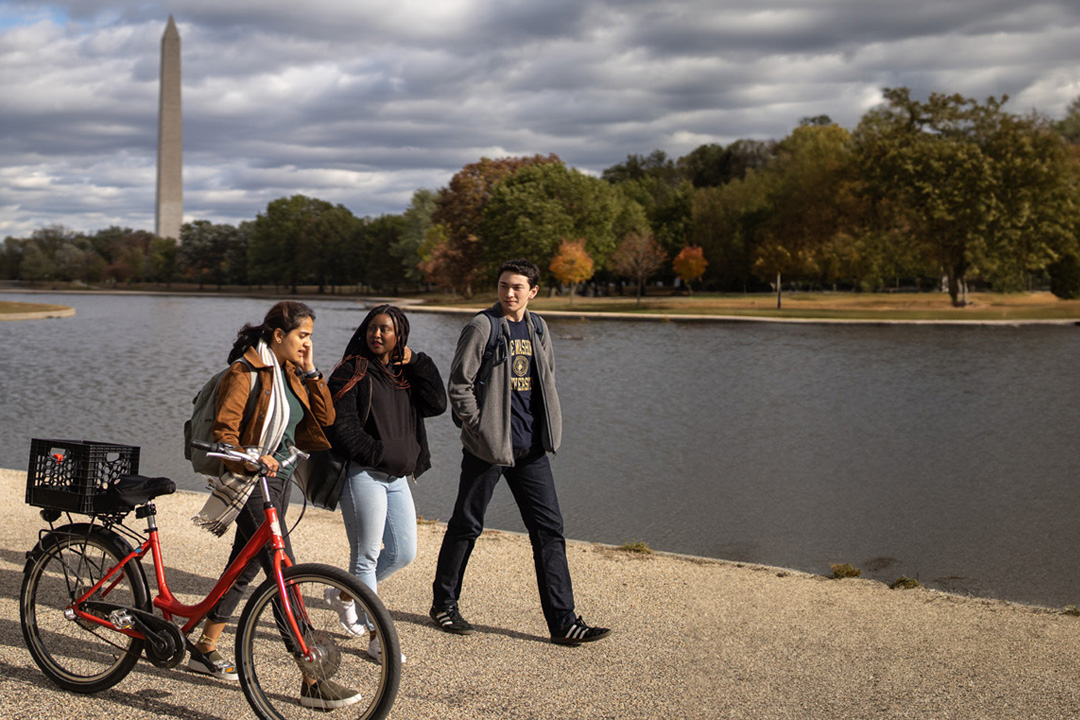 Three students walking at the Tidal Basin.