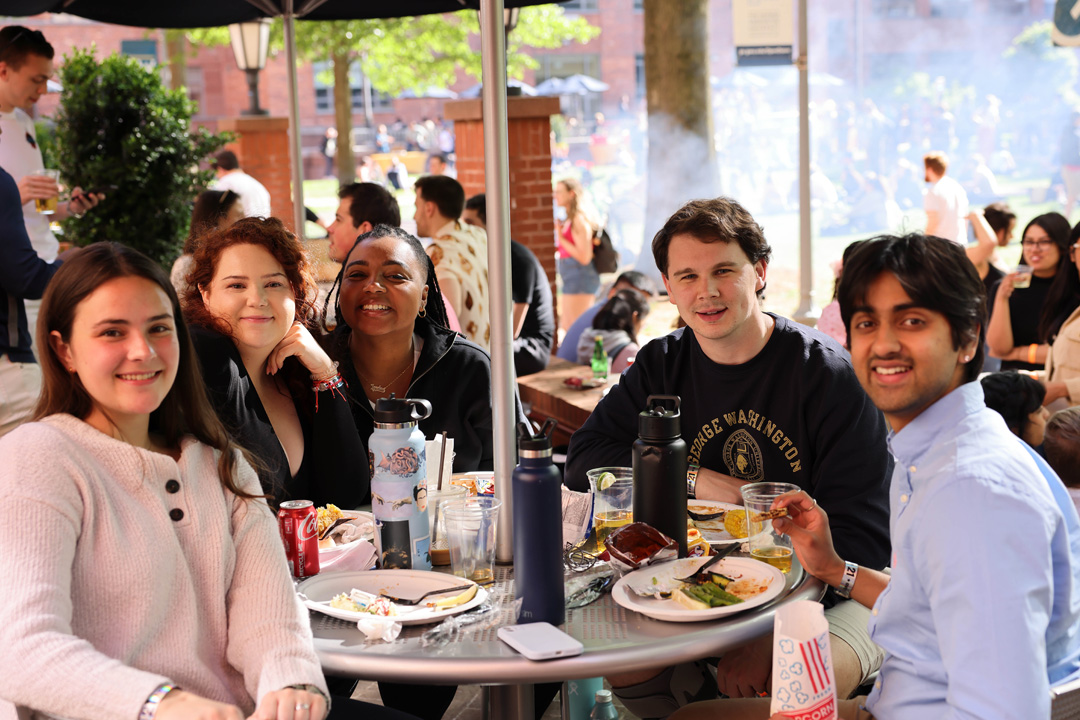 A group of students sitting at a table during Deans Jeans Day.
