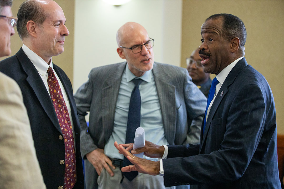 Professor Morant speaks with faculty members.