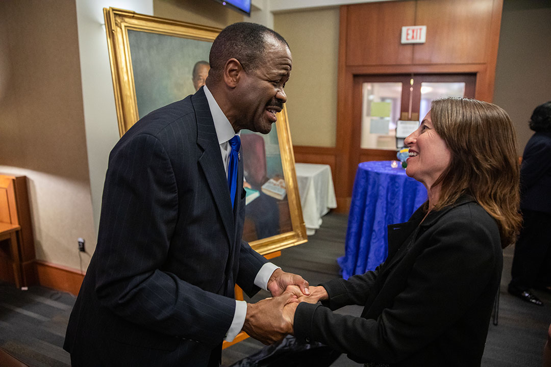 Professor Morant speaks with a faculty member.