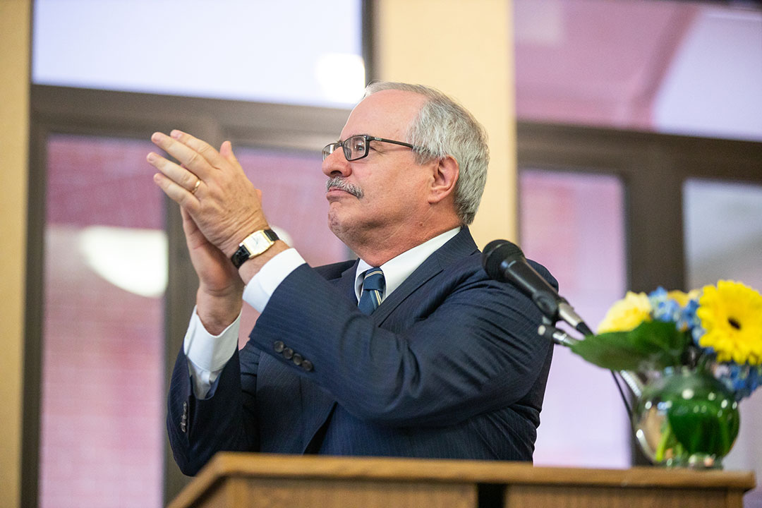 GW President Thomas J. LeBlanc claps for Dean Morant at his portrait unveiling.