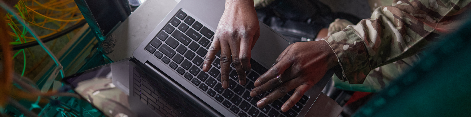 Person working on computer surrounded by wires