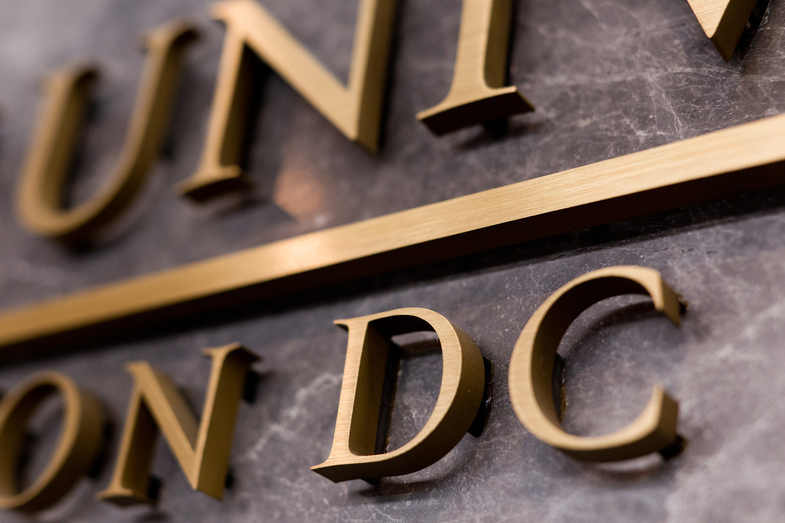 Close up of a George Washington University plaque, focused on the word "DC"