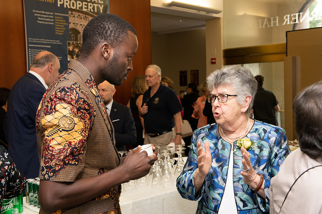 Judge Elizabeth Odio Benito speaks with GW Law student Mutasim Ali.