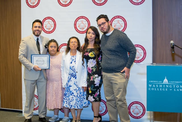 Alfredo De La Cruz stands with his family after being recognized by the Hispanic Bar Association Foundation
