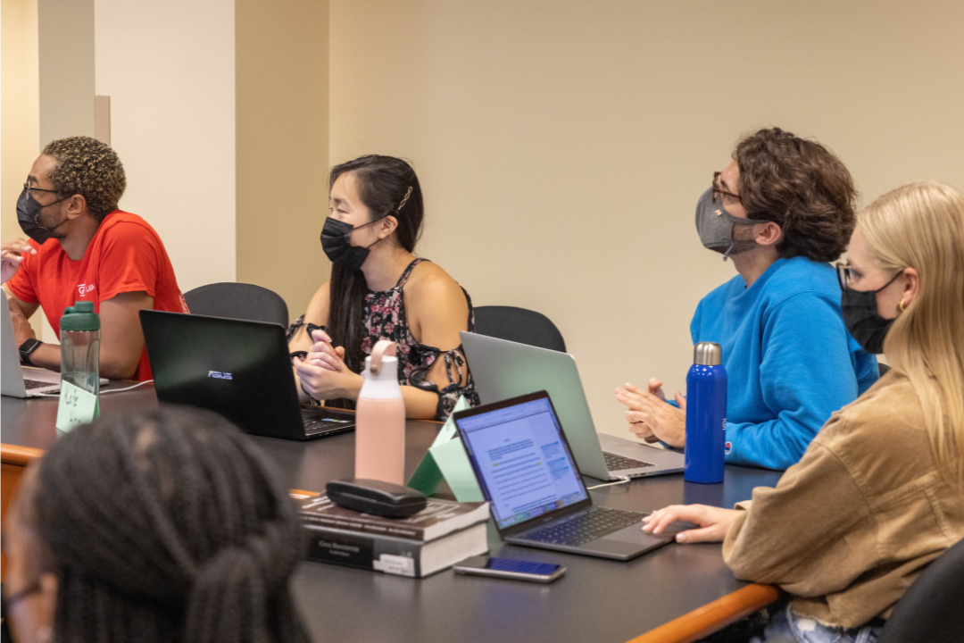 students in class with laptops